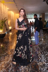 Pooja Hegde in a black saree while attending Acharya movie press meet