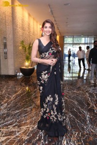 Pooja Hegde in a black saree while attending Acharya movie press meet