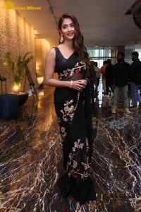 Pooja Hegde in a black saree while attending Acharya movie press meet