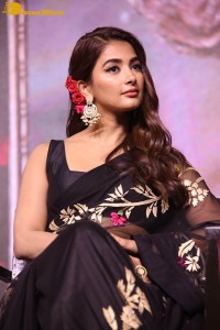 Pooja Hegde in a black saree while attending Acharya movie press meet