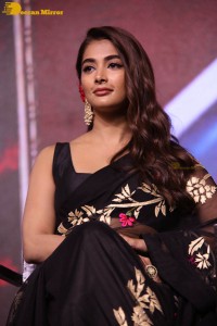 Pooja Hegde in a black saree while attending Acharya movie press meet