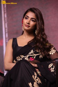Pooja Hegde in a black saree while attending Acharya movie press meet