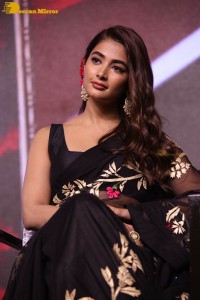Pooja Hegde in a black saree while attending Acharya movie press meet