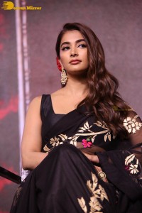 Pooja Hegde in a black saree while attending Acharya movie press meet