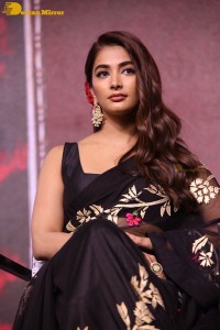 Pooja Hegde in a black saree while attending Acharya movie press meet