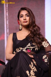 Pooja Hegde in a black saree while attending Acharya movie press meet