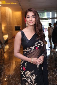 Pooja Hegde in a black saree while attending Acharya movie press meet