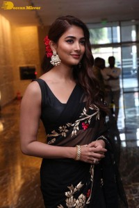 Pooja Hegde in a black saree while attending Acharya movie press meet
