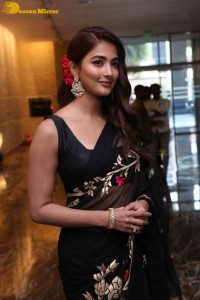 Pooja Hegde in a black saree while attending Acharya movie press meet