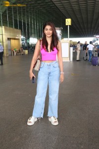 actress pooja hegde cute in a pink top and denim jeans at airport