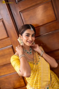 actress Pooja Hegde stunning looks in a yellow saree