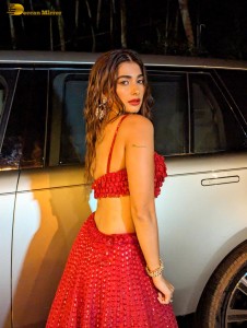 actress Pooja Hegde glamorous photo shoot in a red dress