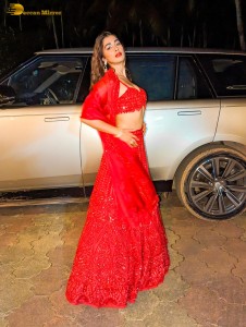 actress Pooja Hegde glamorous photo shoot in a red dress