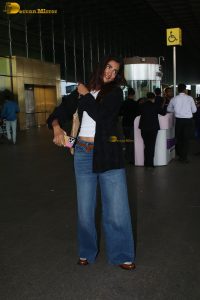 actress pooja hegde in white top and blue jeans at mumbai airport