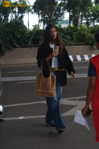 actress pooja hegde in white top and blue jeans at mumbai airport
