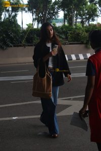 actress pooja hegde in white top and blue jeans at mumbai airport