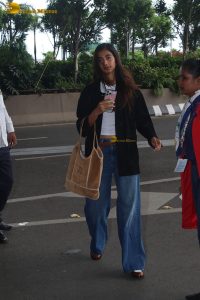 actress pooja hegde in white top and blue jeans at mumbai airport