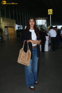 actress pooja hegde in white top and blue jeans at mumbai airport