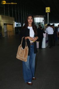 actress pooja hegde in white top and blue jeans at mumbai airport