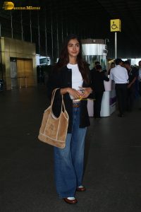 actress pooja hegde in white top and blue jeans at mumbai airport
