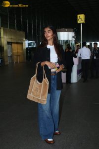 actress pooja hegde in white top and blue jeans at mumbai airport
