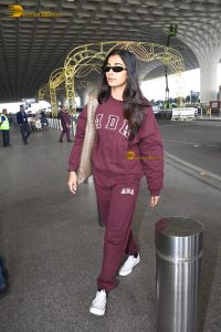 actress pooja hegde cute in red tracksuit at airport