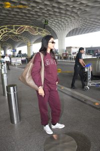 actress pooja hegde cute in red tracksuit at airport
