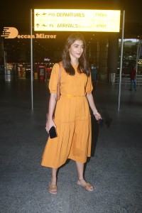 Actress Pooja Hegde in a Yellow Dress at the Airport