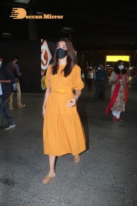 Actress Pooja Hegde in a Yellow Dress at the Airport