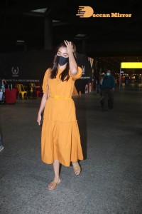 Actress Pooja Hegde in a Yellow Dress at the Airport