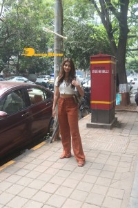 Pooja Hegde in a white top and brown pants