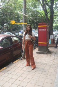 Pooja Hegde in a white top and brown pants