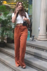 Pooja Hegde in a white top and brown pants