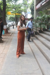 Pooja Hegde in a white top and brown pants