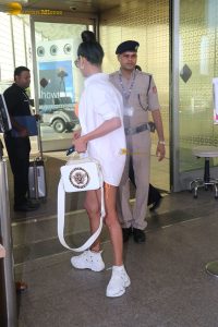 actress Poonam Pandey in a short orange dress at airport