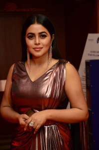 Actress Poorna in a shiny maroon dress