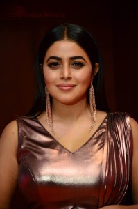 Actress Poorna in a shiny maroon dress