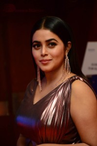 Actress Poorna in a shiny maroon dress
