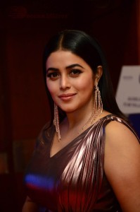 Actress Poorna in a shiny maroon dress