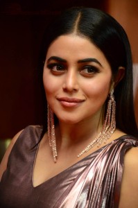 Actress Poorna in a shiny maroon dress