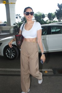 actress Pragya Jaiswal sexy in a white top and khaki pants