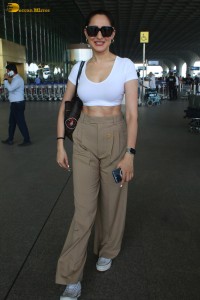 actress Pragya Jaiswal sexy in a white top and khaki pants
