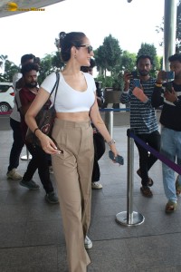 actress Pragya Jaiswal sexy in a white top and khaki pants