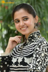 Tollywood actress preethi asrani in a black and white dress