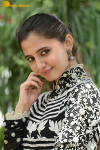 Tollywood actress preethi asrani in a black and white dress