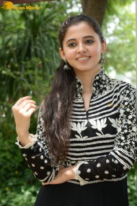 Tollywood actress preethi asrani in a black and white dress