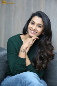 actress priya bhavani shankar in a green top and denim jeans