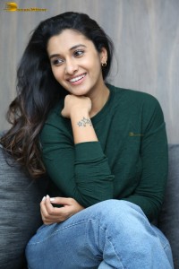 actress priya bhavani shankar in a green top and denim jeans