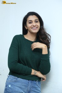 actress priya bhavani shankar in a green top and denim jeans