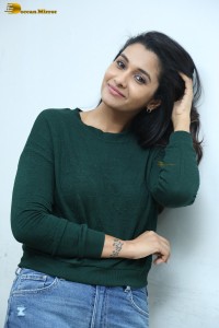 actress priya bhavani shankar in a green top and denim jeans